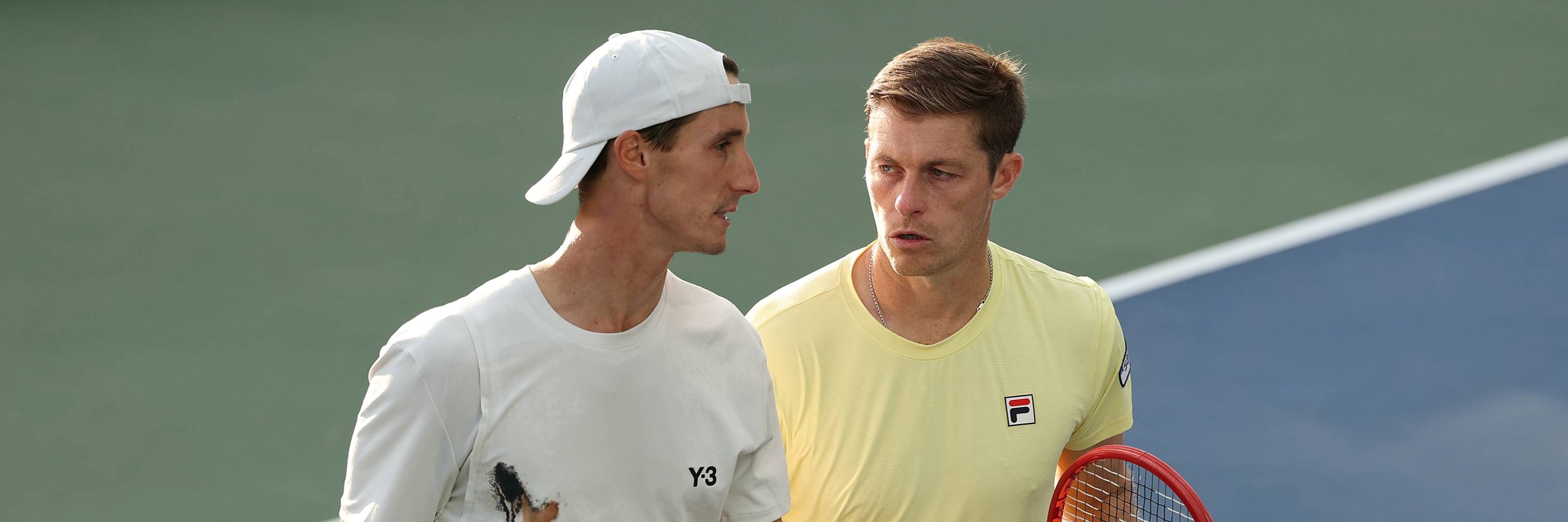 Joe Salisbury and Neal Skupski talking on court during their third round win at the 2025 US Open