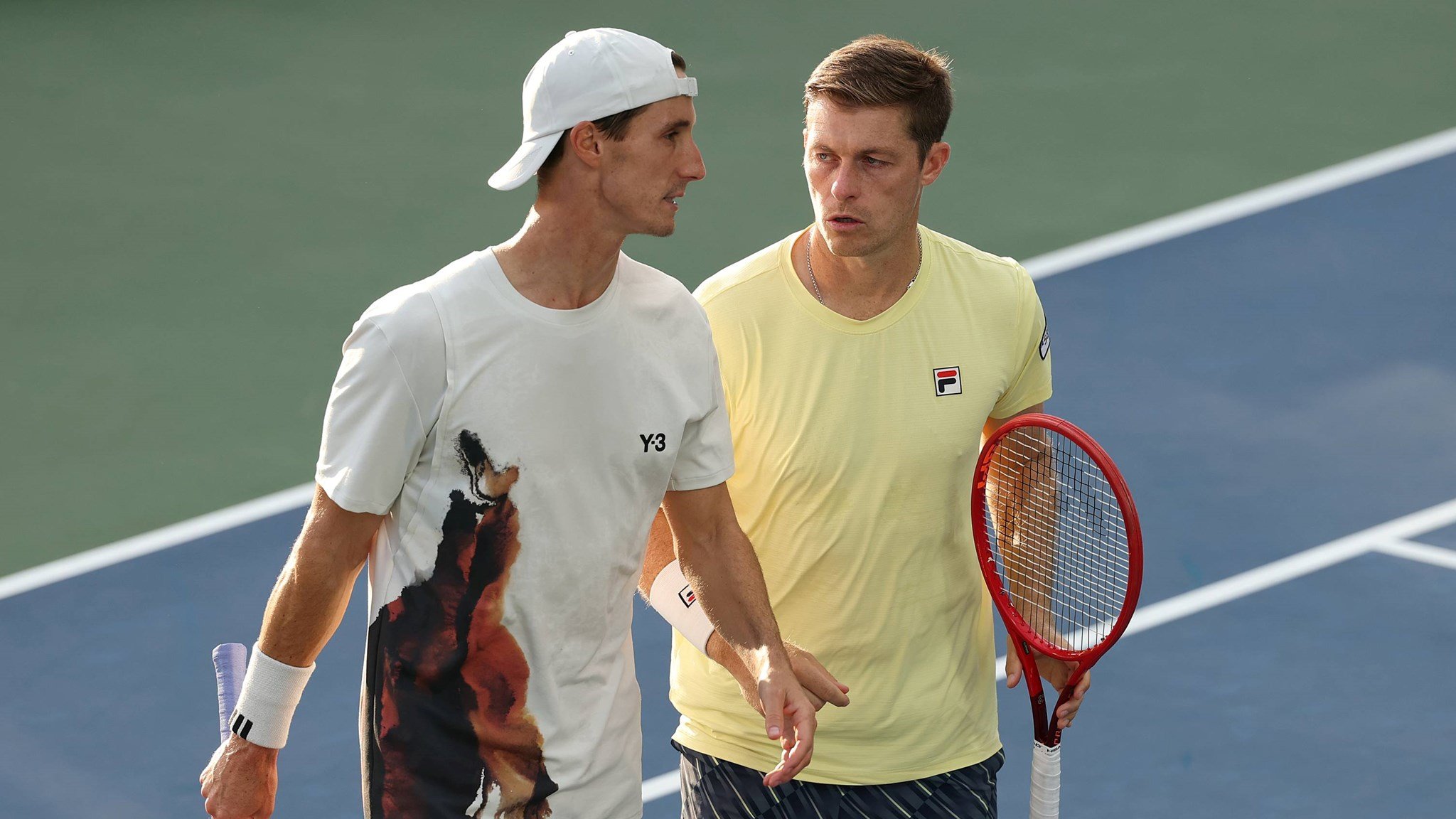 Joe Salisbury and Neal Skupski talking on court during their third round win at the 2025 US Open