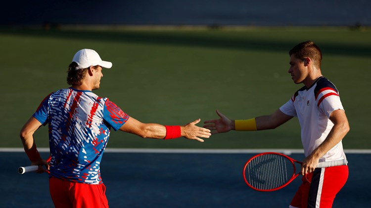 Neal Skupski and Wesley Koolhof interacting during their second round match at the 2022 US Open