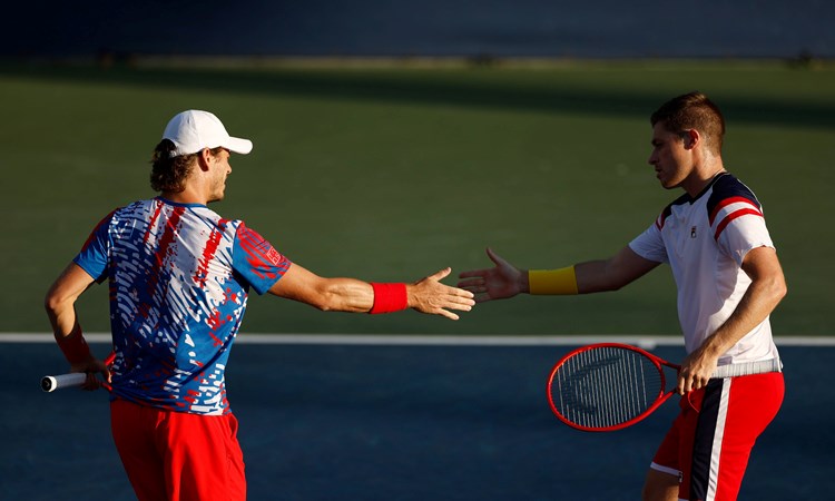 Neal Skupski and Wesley Koolhof interacting during their second round match at the 2022 US Open