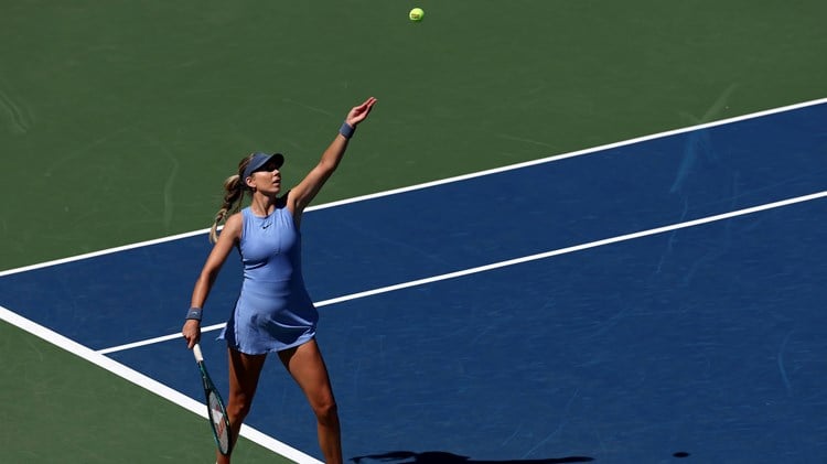 Katie Boulter throws up the ball to hit a serve in the first round of the US Open