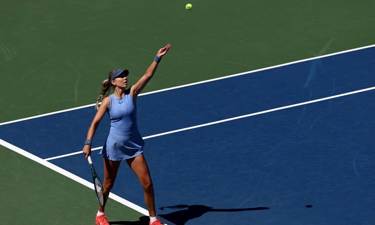 Katie Boulter throws up the ball to hit a serve in the first round of the US Open