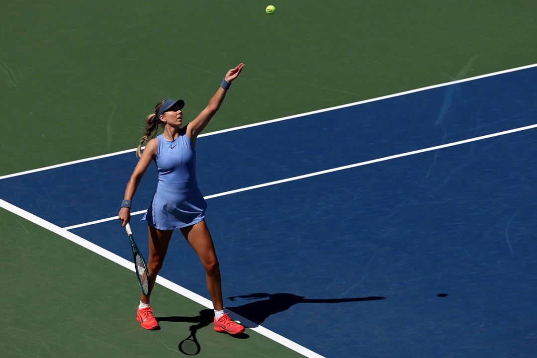 Katie Boulter throws up the ball to hit a serve in the first round of the US Open