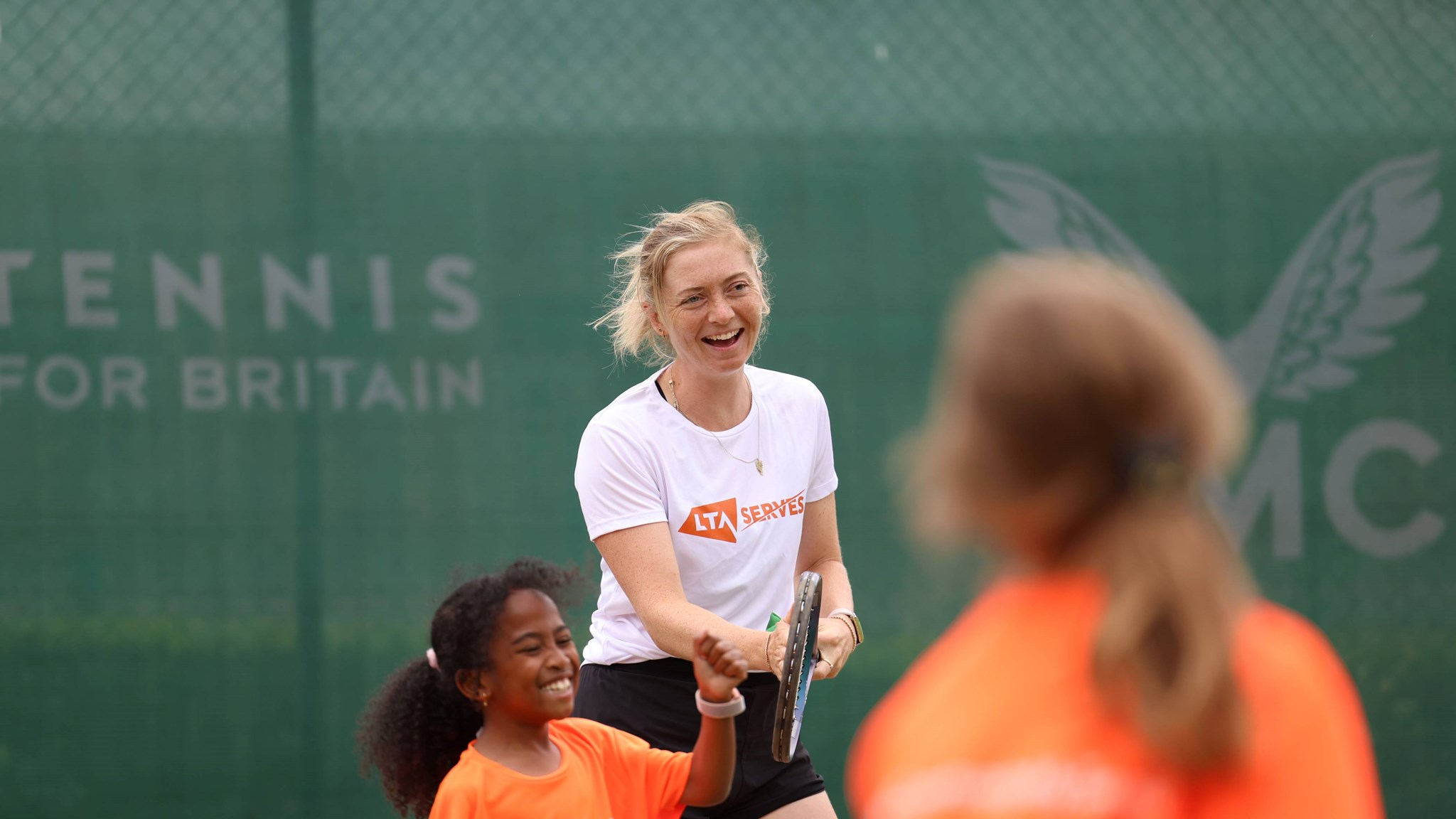 Alicia Barnett laughs while playing at an LTA SERVES event