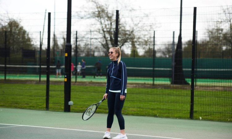 Player laughing on court during a Free Park Tennis session