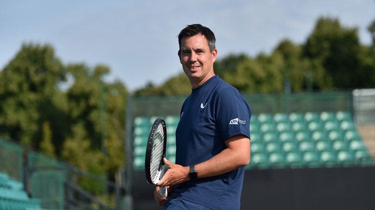 The LTA's Wheelchair Tennis head coach Rob Cross poses for a picture with a racket in hand