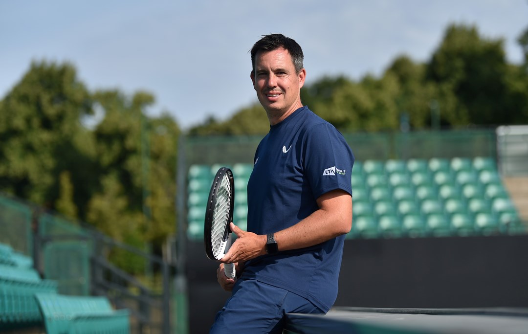 The LTA's Wheelchair Tennis head coach Rob Cross poses for a picture with a racket in hand