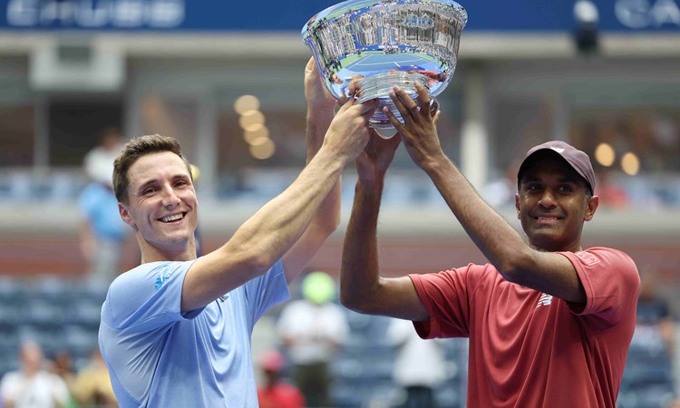 Joe Salisbury and Rajeev Ram lifting their championship trophy on court at the US Open