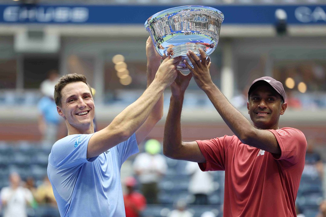 Joe Salisbury and Rajeev Ram lifting their championship trophy on court at the US Open