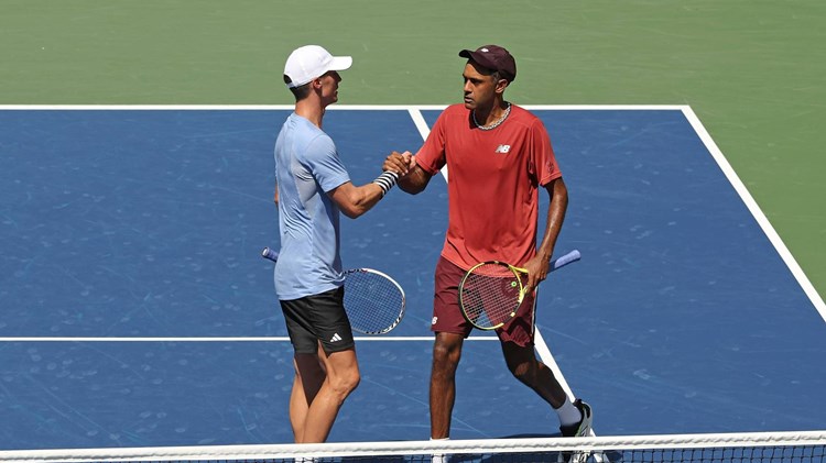 Joe Salisbury and Rajeev Ram high five on court at the US Open