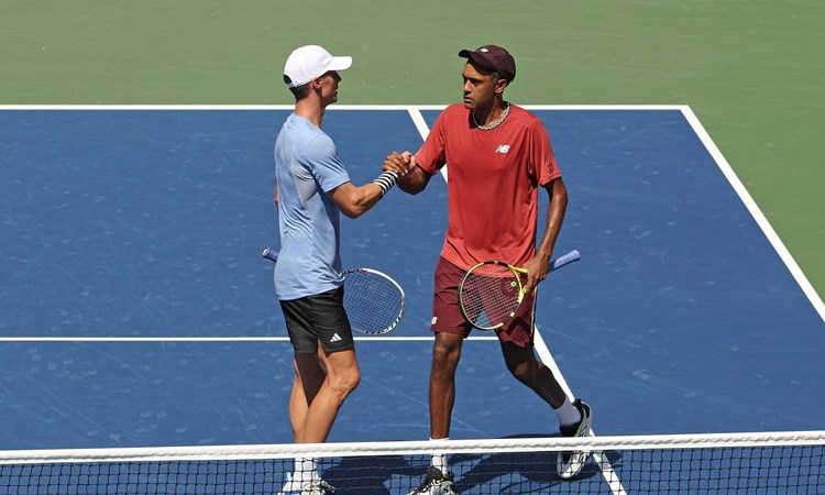 Joe Salisbury and Rajeev Ram high five on court at the US Open