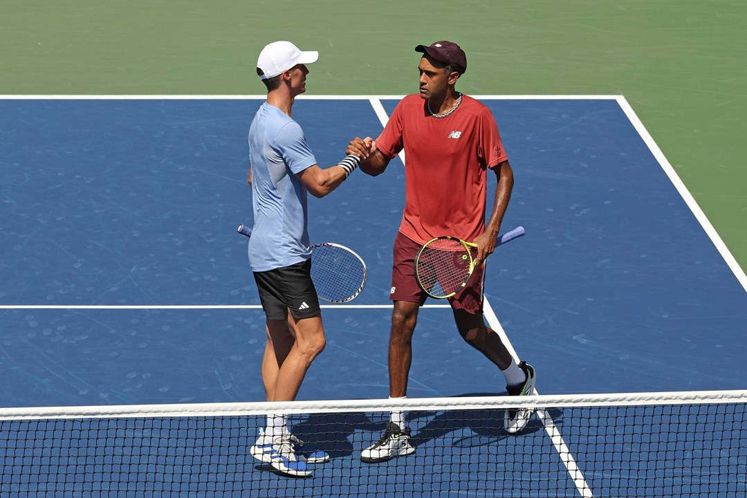 Joe Salisbury and Rajeev Ram high five on court at the US Open