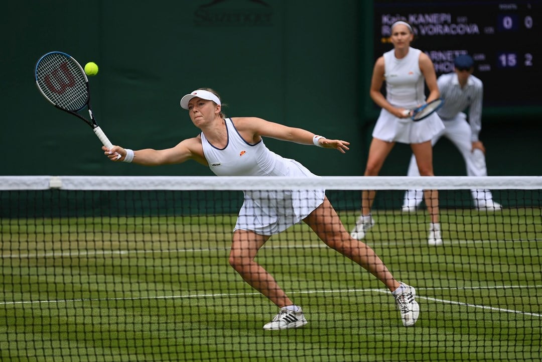 Alicia Barnett stretches for a volley in the first round at Wimbledon 2022