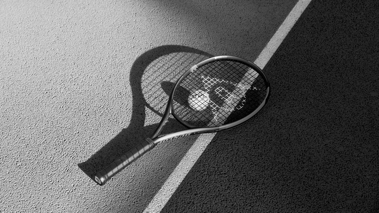 Tennis racket lying on a court