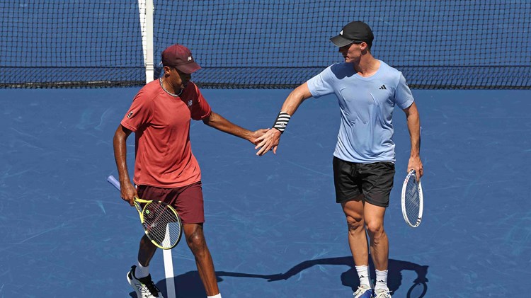 Joe Salisbury and Rajeev Ram high fiving on court at the US Open