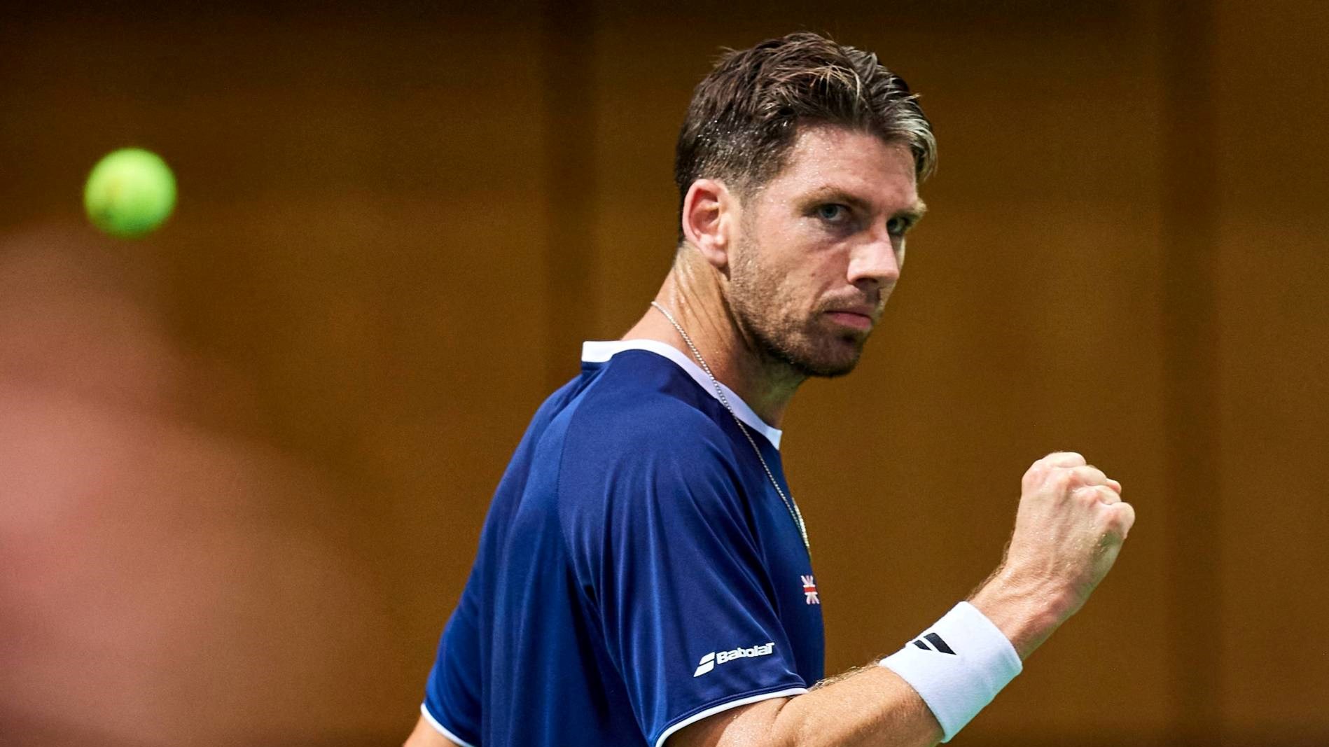 Cam Norrie gives a fist pump after winning a point in the Davis Cup against Poland