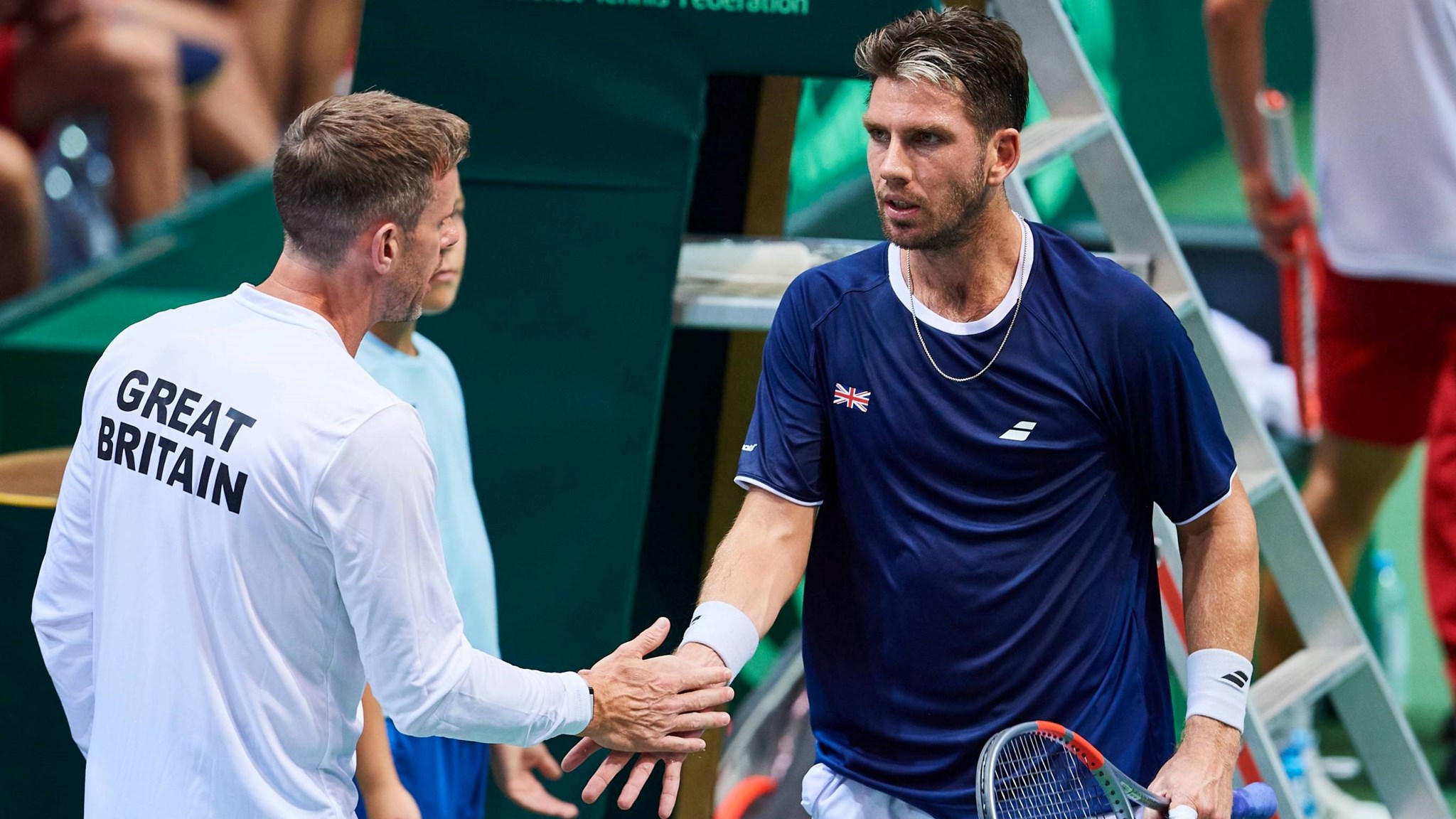 Cam Norrie and Leon Smith high five during GB's Davis Cup tie against Poland