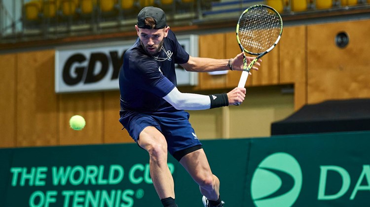 Jacob Fearnley lines up a backhand in training at the Davis Cup