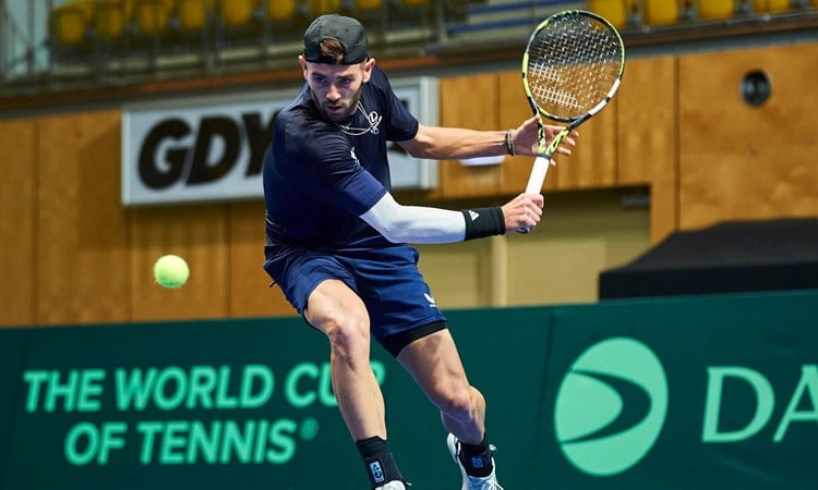 Jacob Fearnley lines up a backhand in training at the Davis Cup