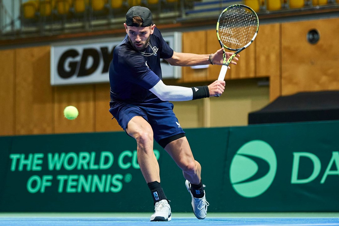 Jacob Fearnley lines up a backhand in training at the Davis Cup