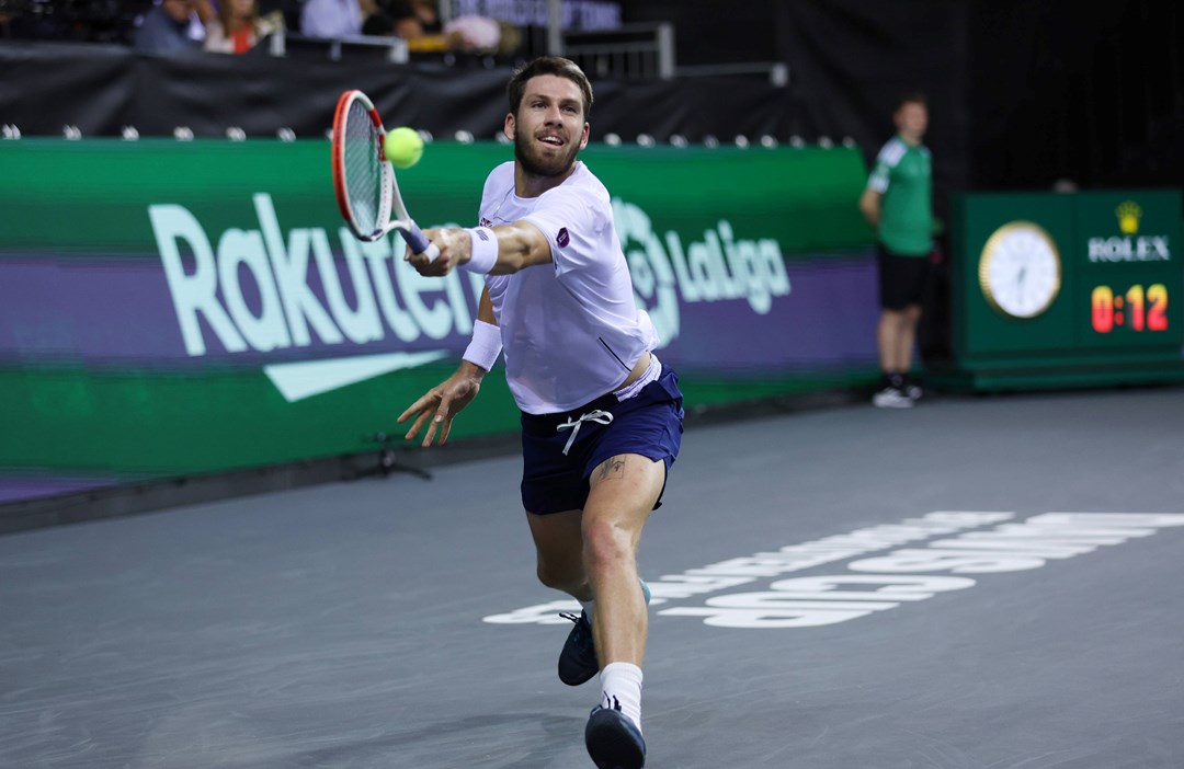 Cam Norrie stretches for a backhand against Taylor Fritz at the Davis Cup Finals 2022