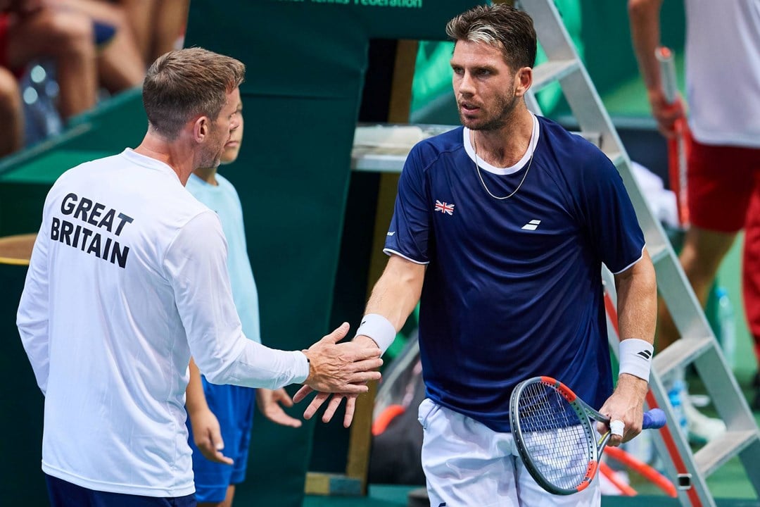 Cam Norrie and Leon Smith high five during GB's Davis Cup tie against Poland