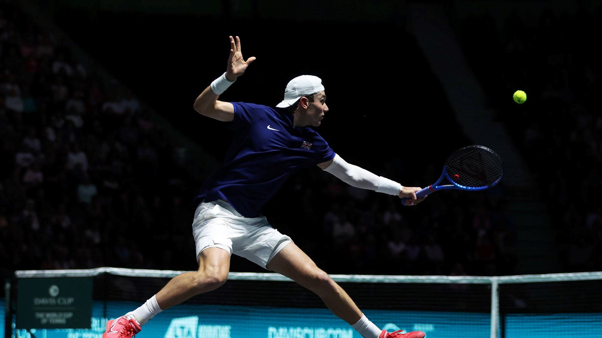 Jack Draper stretches for a backhand against Felix Auger-Aliassime at the Davis Cup