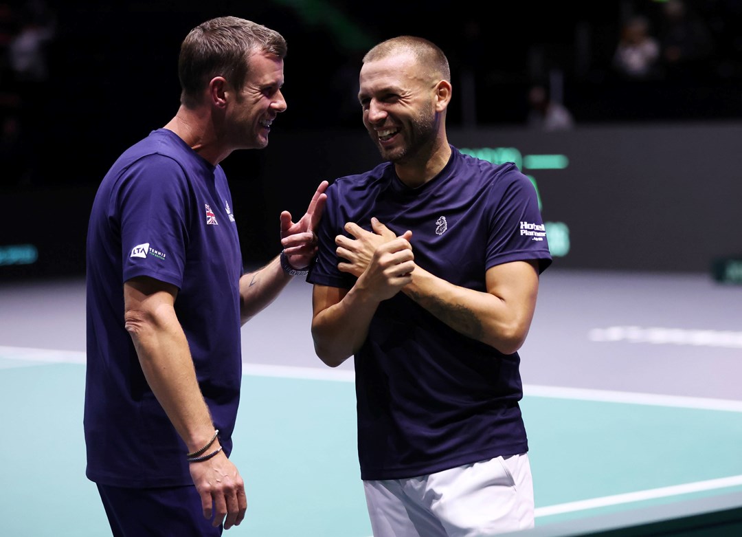 Leon Smith and Dan Evans laughing on court at the Davis Cup