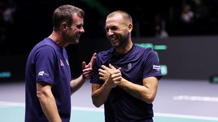 Leon Smith and Dan Evans laughing on court at the Davis Cup