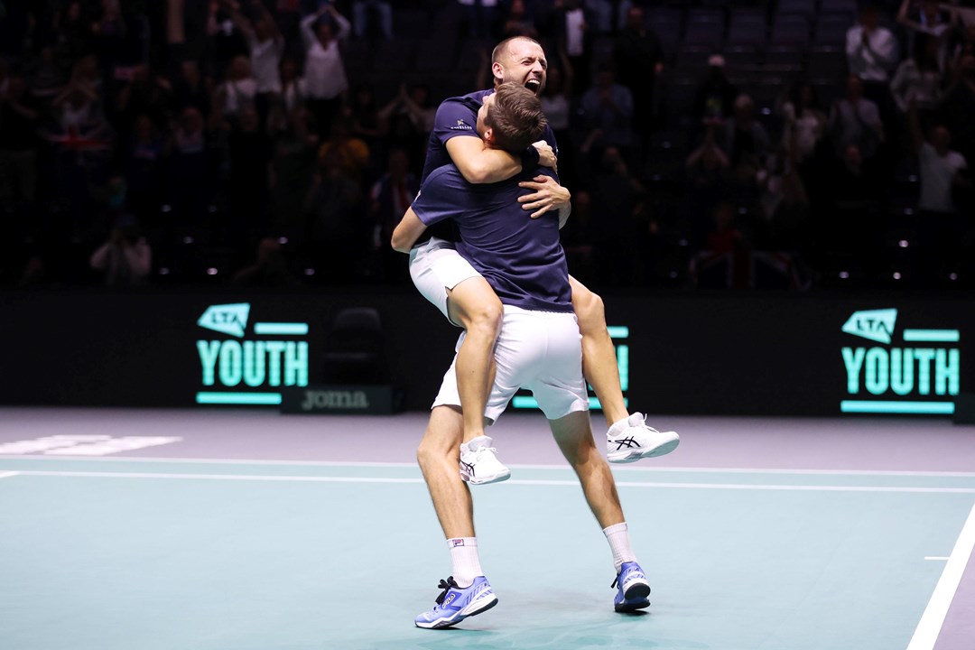 Dan Evans and Neal Skupski hug after clinching the doubles decider at the Davis Cup against France