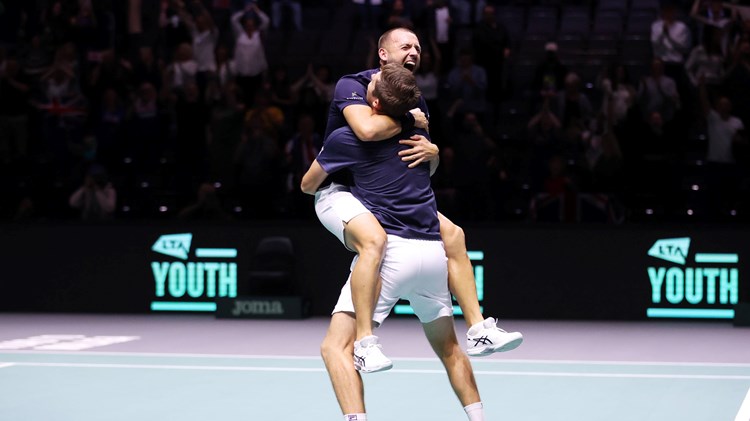 Dan Evans and Neal Skupski hug after clinching the doubles decider at the Davis Cup against France