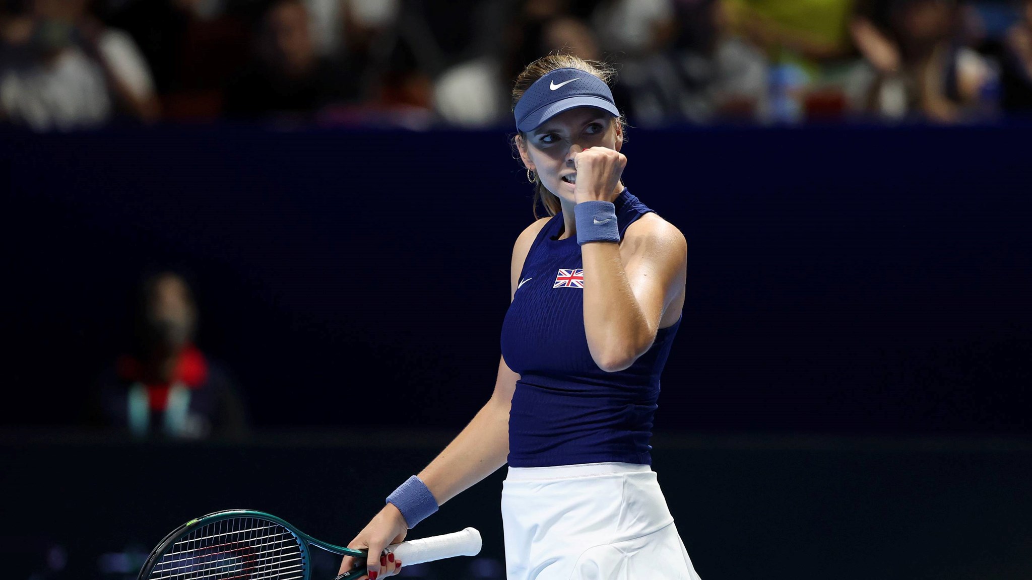 British tennis player Katie Boulter clenching her fist on court after winning a point during Great Britain's Billie Jean King Cup tie against Japan