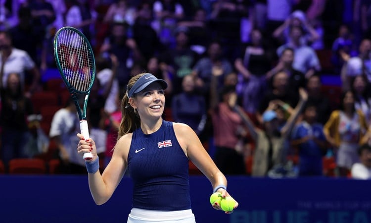 British tennis player Katie Boulter smiling while holding her racket in the air at the Billie Jean King Cup Finals in Shenzhen
