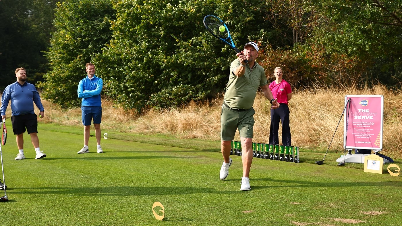 Man taking part in Longest Serve competition at LTA Tennis Foundation Golf Day 