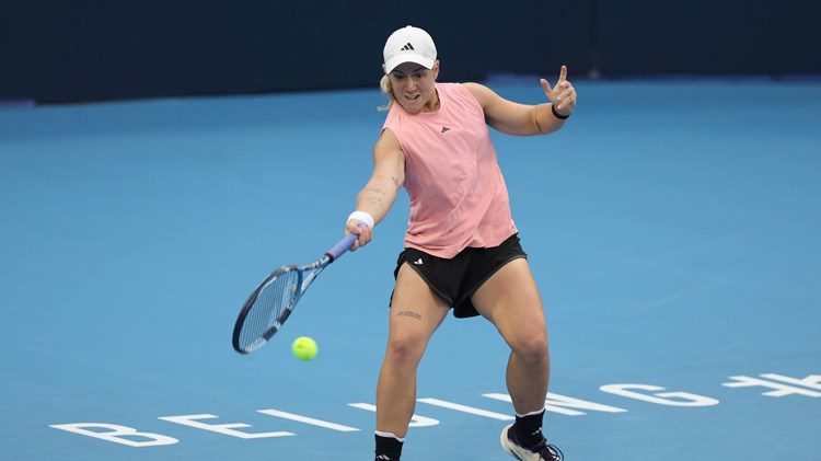British tennis player Sonay Kartal bending down low to hit a forehand on court at the China Open