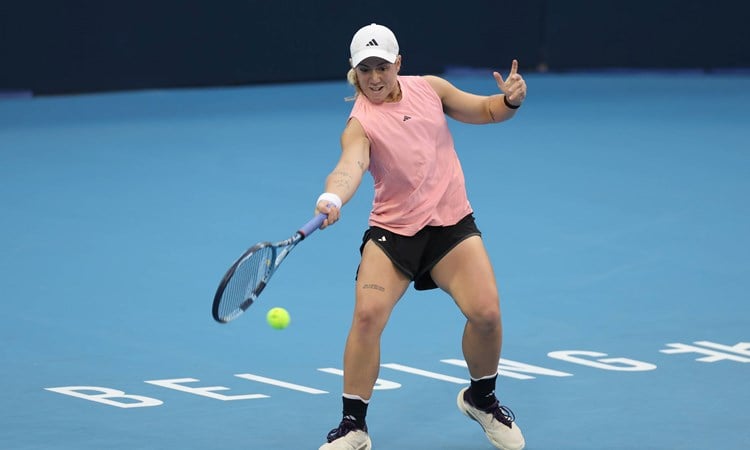 British tennis player Sonay Kartal bending down low to hit a forehand on court at the China Open