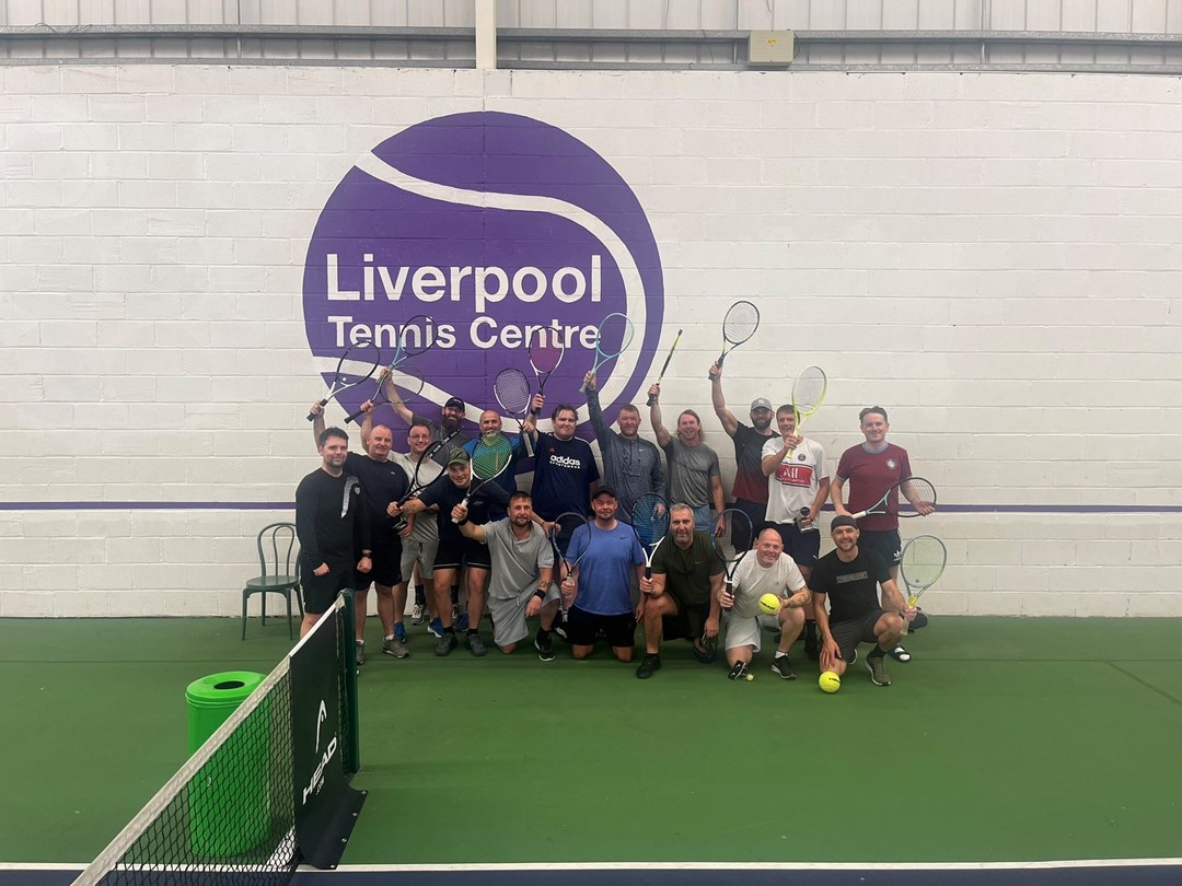 Residents of the Damien John Kelly House in Liverpool pictured on court holding their rackets above their head during a tennis session at the Liverpool Tennis Centre.