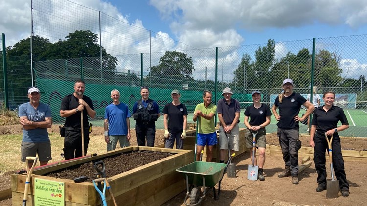 Totnes Community Tennis Club players and local police force helping build the community garden