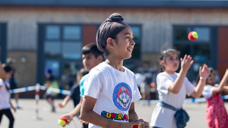 Child taking part in an LTA SERVES session