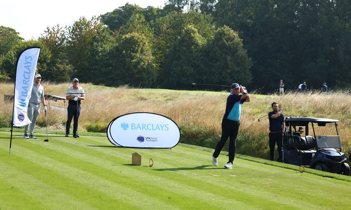 Golfers teeing off at Barclays hole 