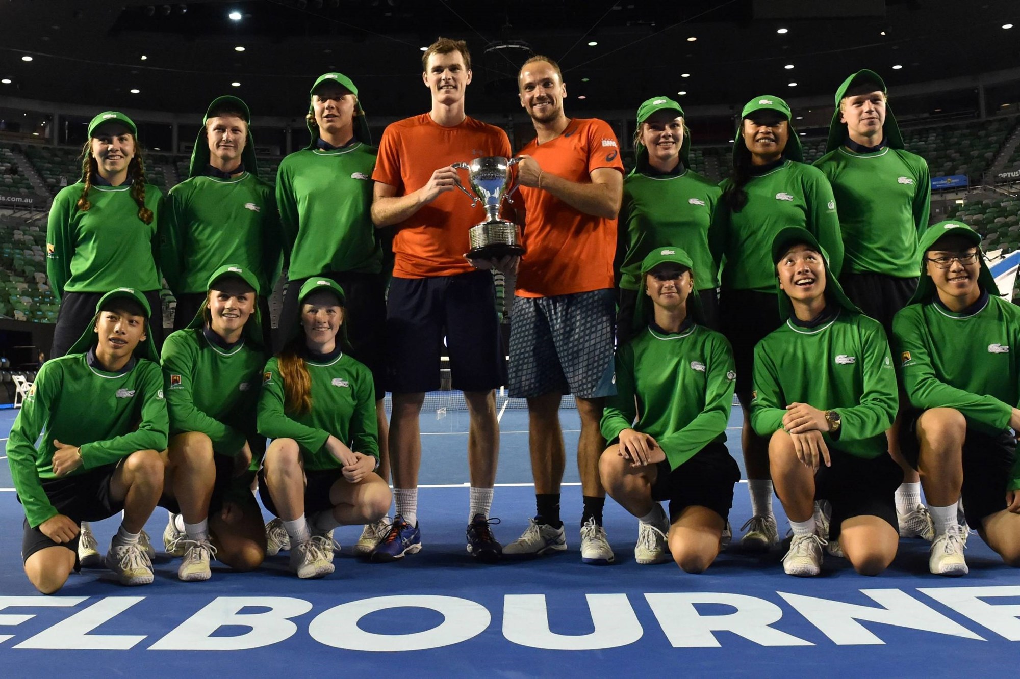 Jamie Murray and Bruno Soares holding the 2016 Australian Open title with the ball kids