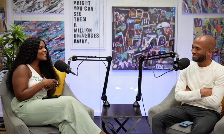 An image of Black Spin Global podcast hosts Eugene and Lucy sat recording an episode of their podcast