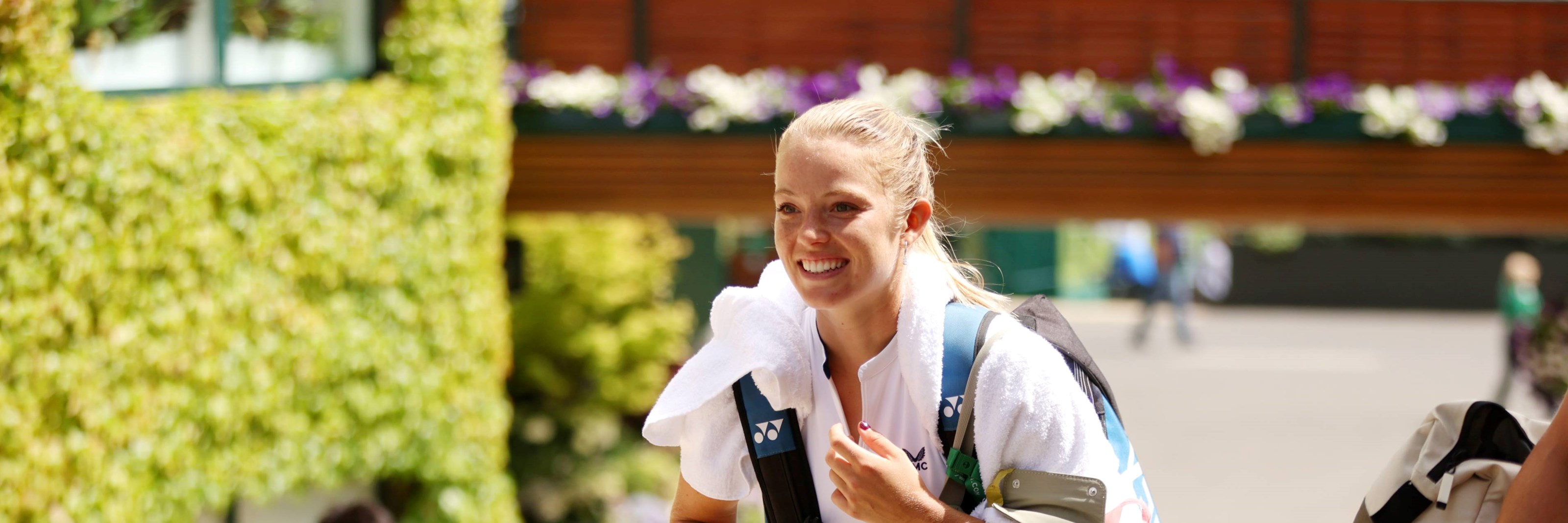 Katie Swan walking to court around the grounds at Wimbledon