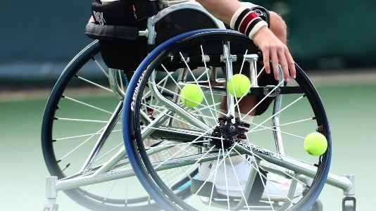 Wheelchair close up with tennis balls in wheel of chair