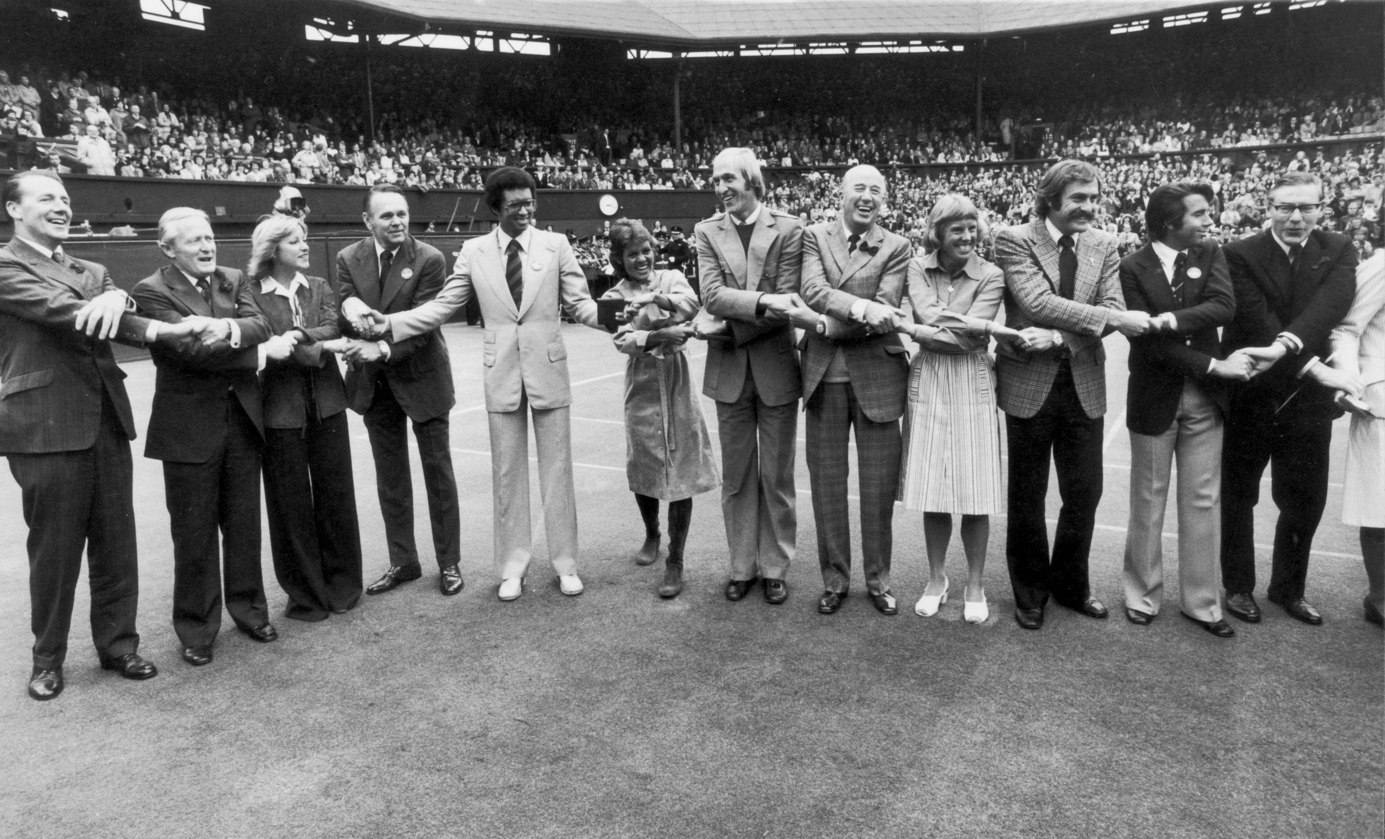 Arthur Ashe holding the Wimbledon trophy, a symbol of his groundbreaking achievements