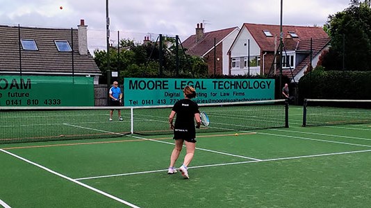 Family playing a game of tennis