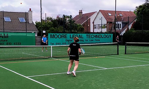 Family playing a game of tennis