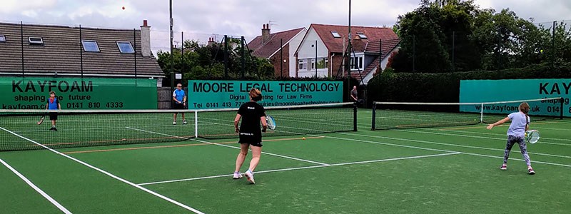 Family playing a game of tennis