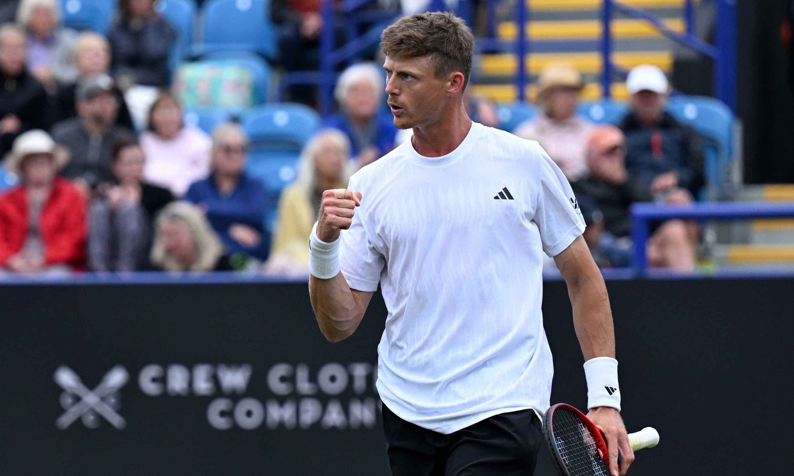 British tennis player Billy Harris clenching his fist and holding his tennis racket on court 