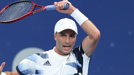 Liam Broady plays a forehand at the 2020 Olympics 